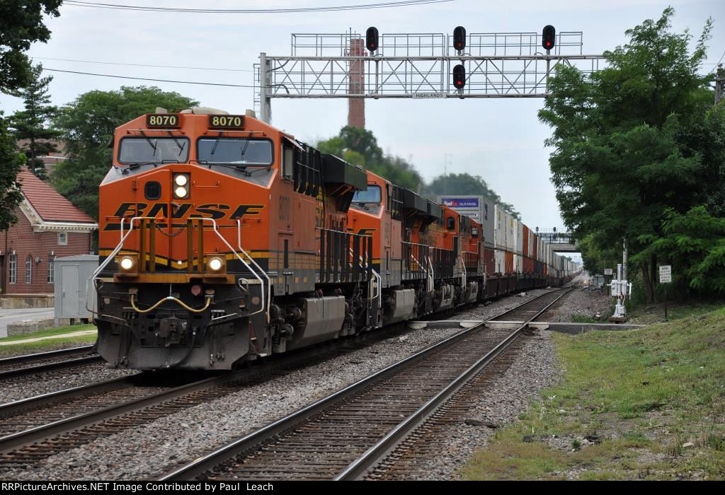 Westbound intermodal races down the middle track of the Racetrack